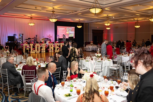 Large lighted letters on stage reading Glow Red
